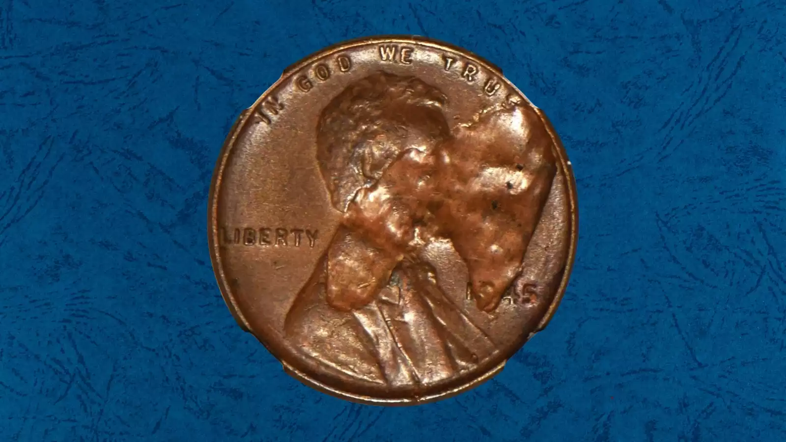 Three 1945 wheat pennies showing color tiers: Red (RD) brilliant copper, Red-Brown (RB) partially toned, and Brown (BN) fully oxidized