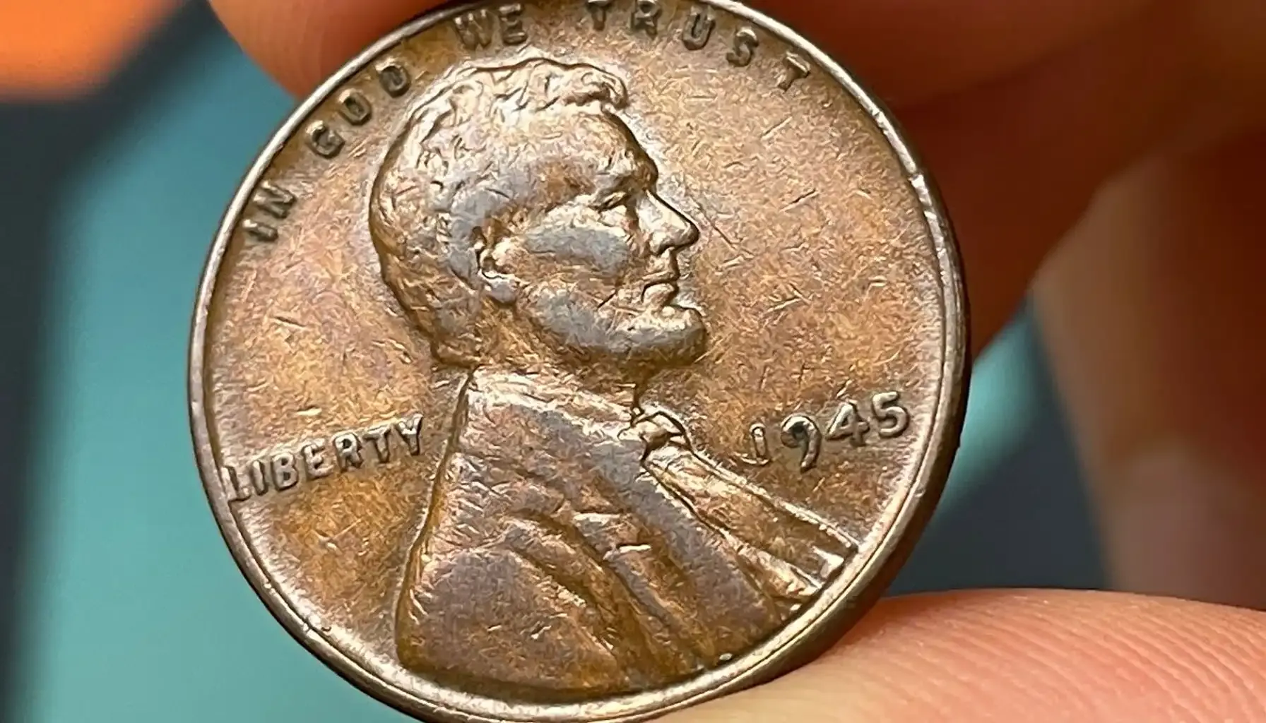 1945 wheat penny off-center strike showing shifted Lincoln portrait with blank copper crescent and full date 1945 readable